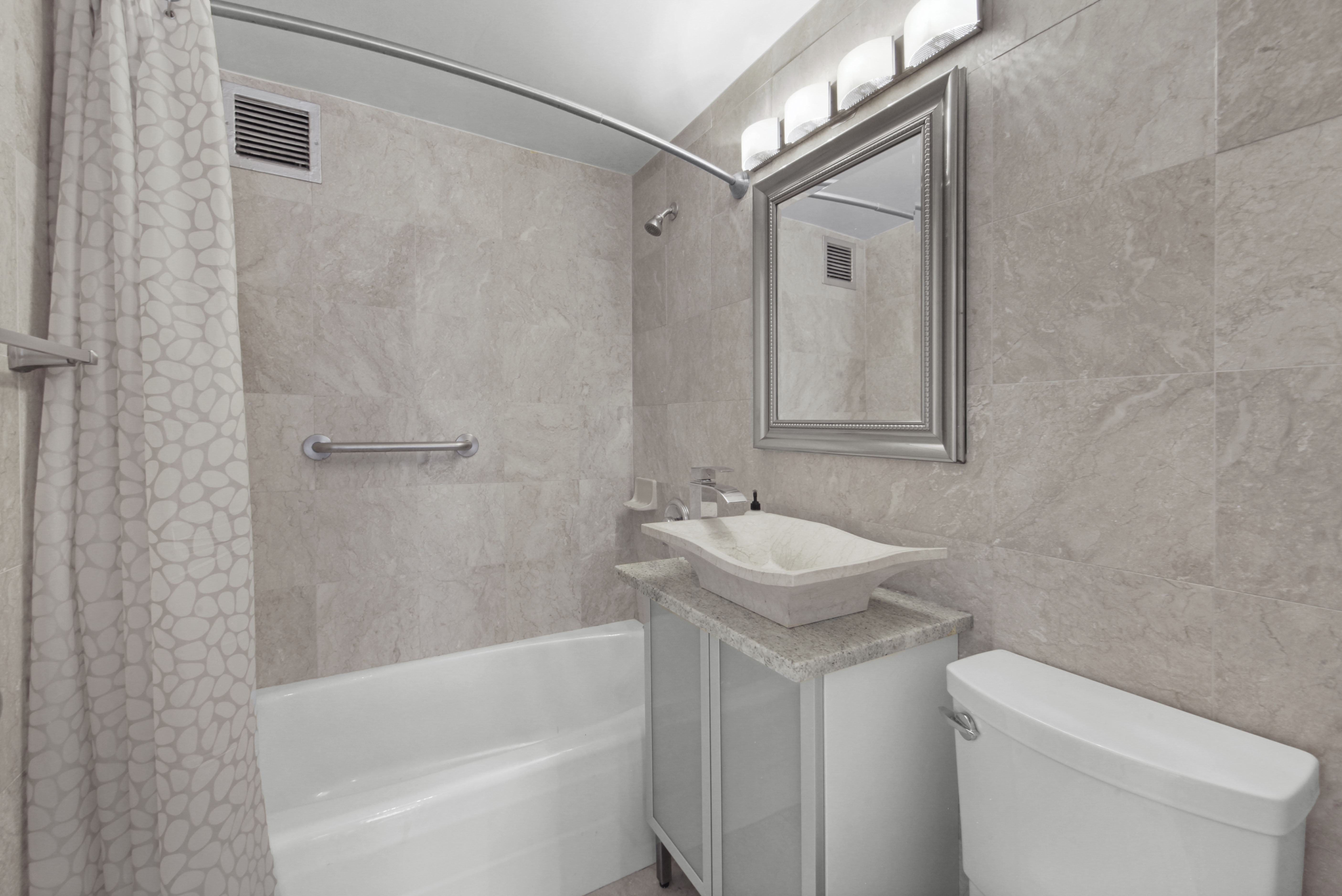 160 East 65th Street, Unit 8A Manhattan, NY 10065 - Photo 10 of 13 a bathroom with a sink toilet and shower