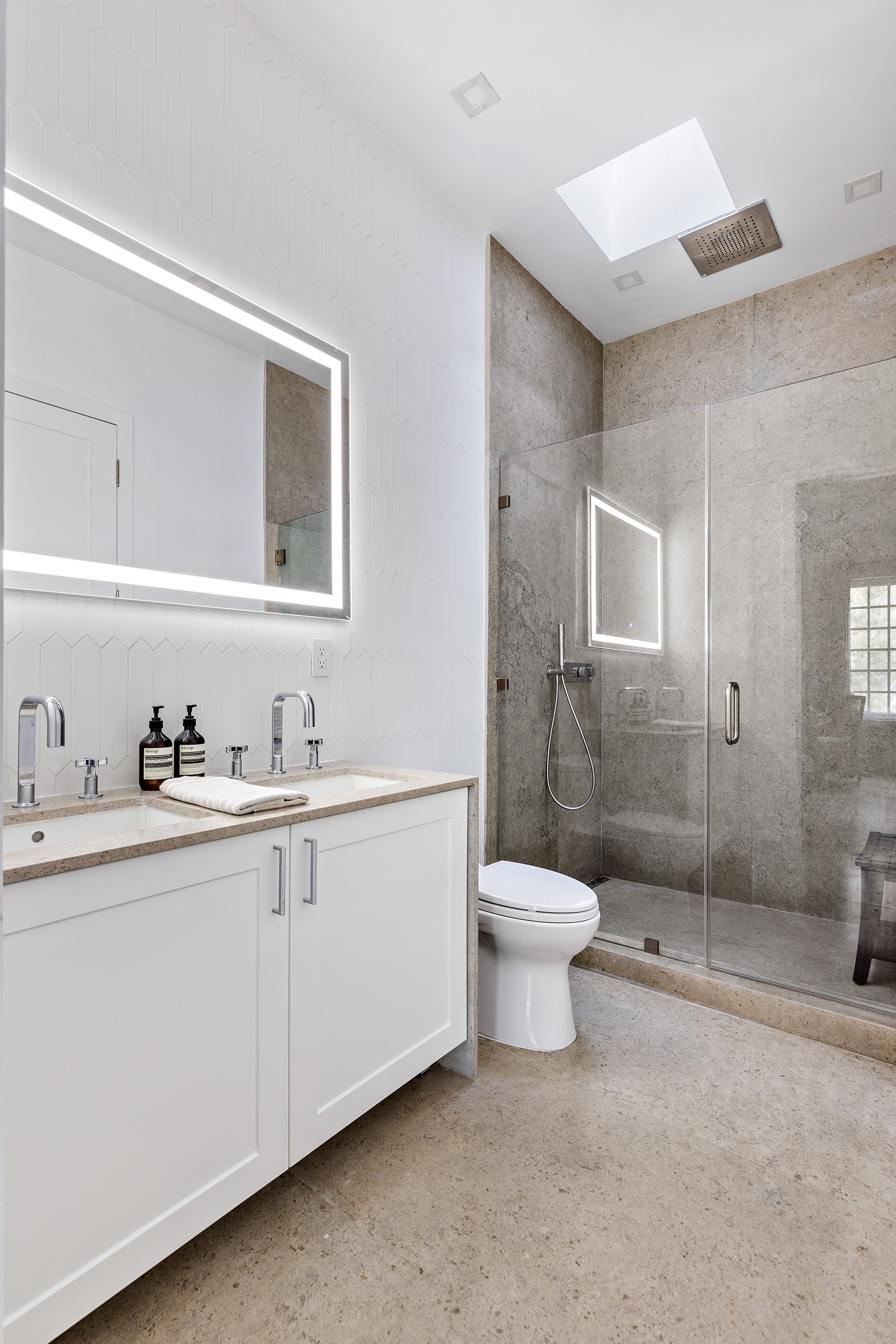 25 East 94th Street Manhattan, NY 10128 - Photo 24 of 33 a bathroom with a sink a toilet and shower