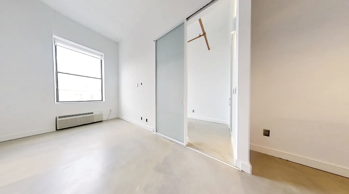 44 Berry Street, Unit 6B Brooklyn, NY 11249 - Photo 3 of 9 an empty room with windows and closet