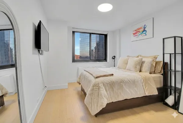 a bedroom with a bed and a window