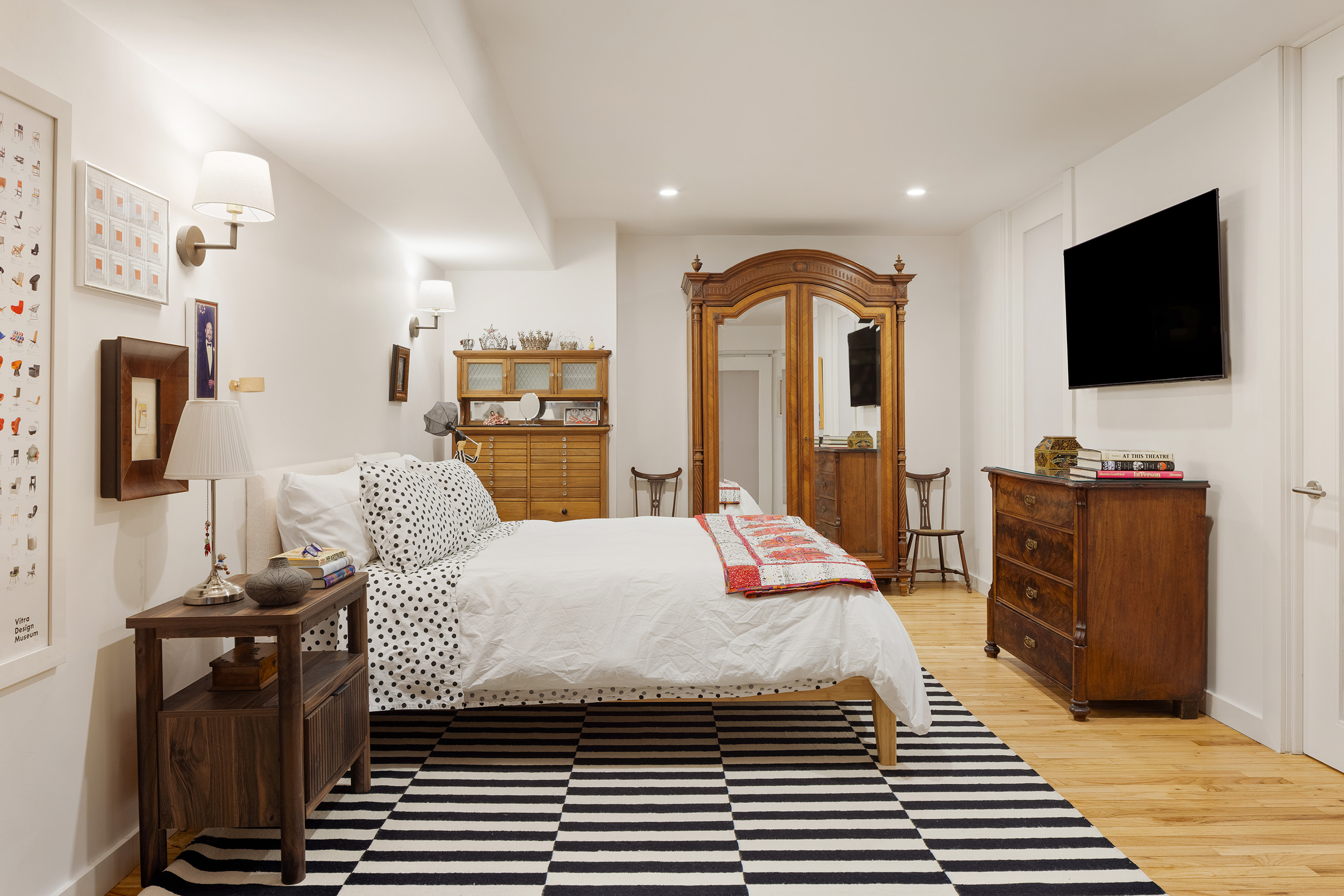 176 Broadway, Unit 3C Manhattan, NY 10038 - Photo 4 of 8 a bedroom with a bed and flat screen tv