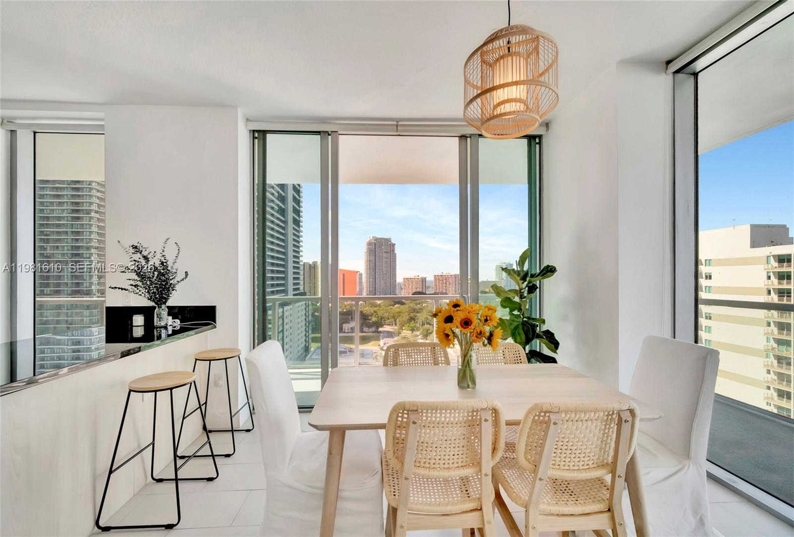 79 Southwest 12th Street, Unit 2201S Miami, FL 33130 - Photo 6 of 33 a dining room with furniture potted plants and wooden floor