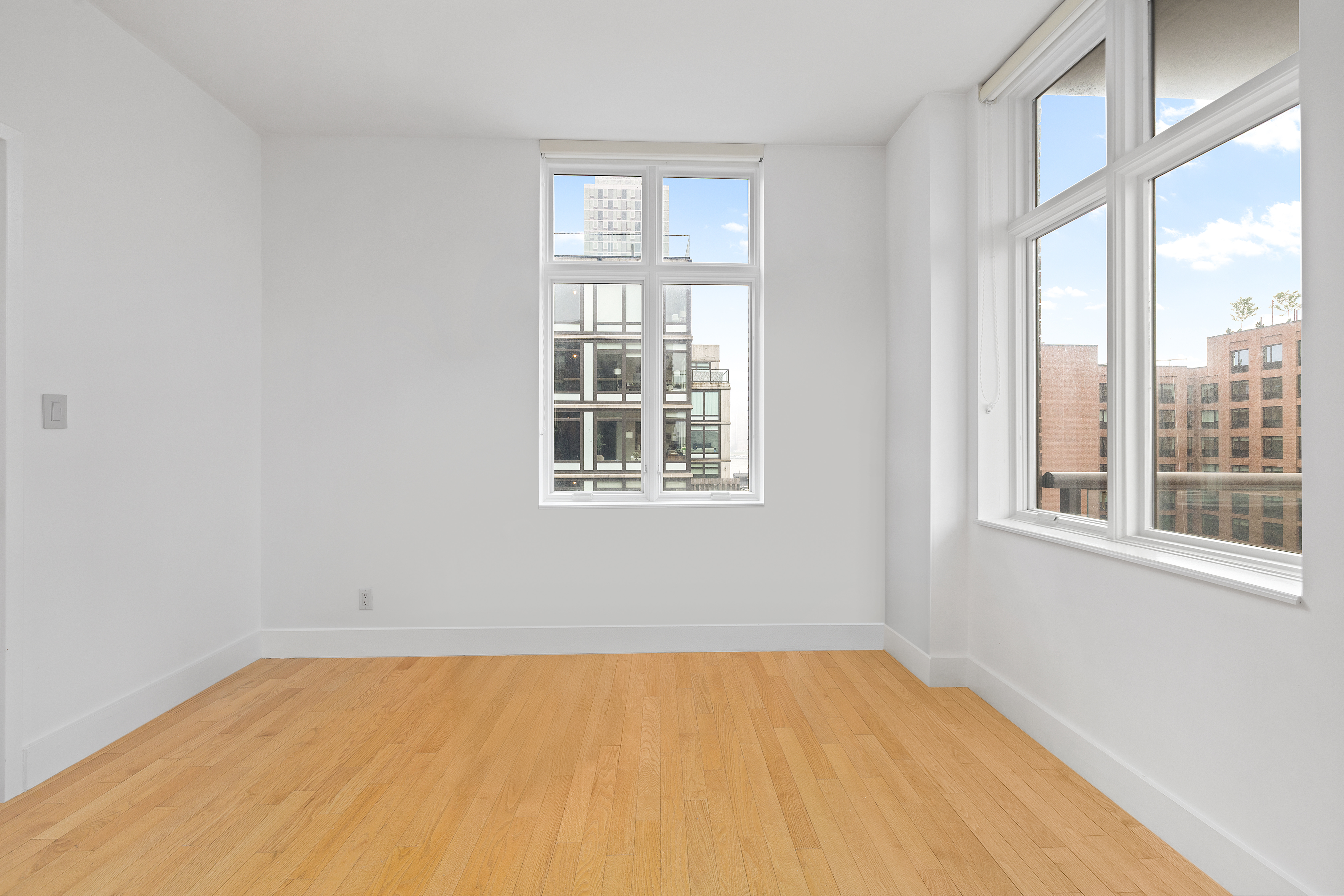 2-26 50th Avenue, Unit 10F Queens, NY 11101 - Photo 3 of 11 a view of an empty room with a window