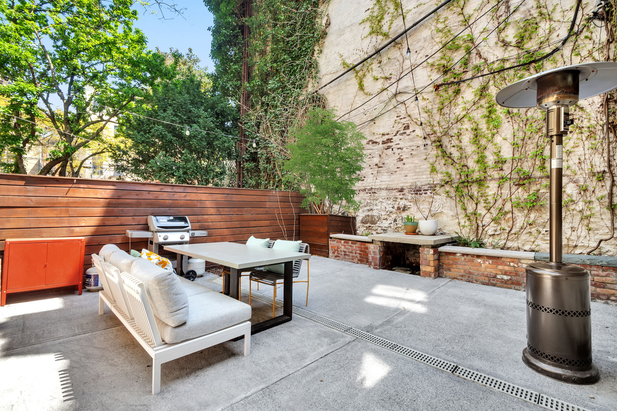 361 6th Avenue, Unit 1 Brooklyn, NY 11215 - Photo 9 of 11 a view of a patio with dining table and chairs with wooden fence