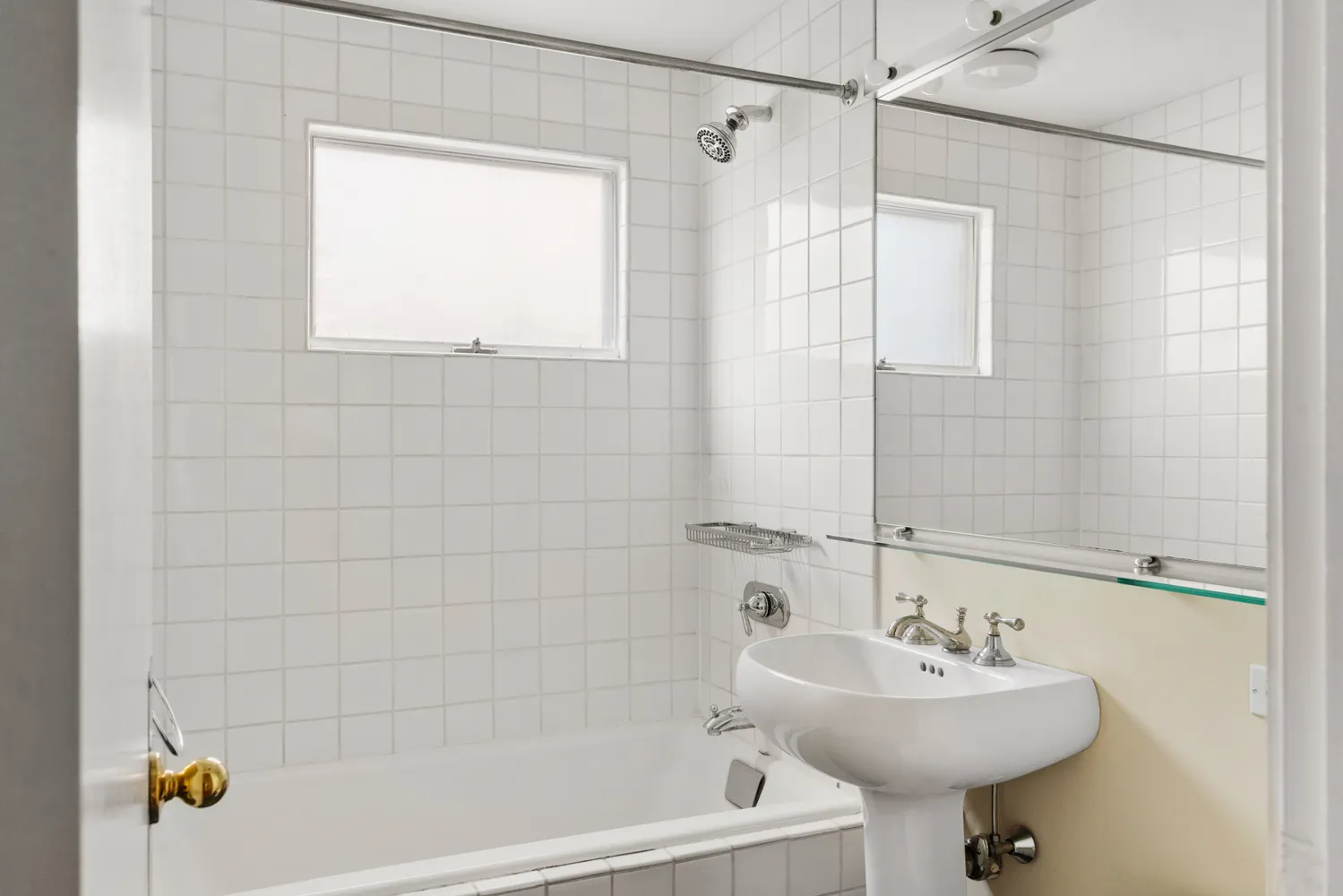 a bathroom with a sink a mirror a bathtub and shower