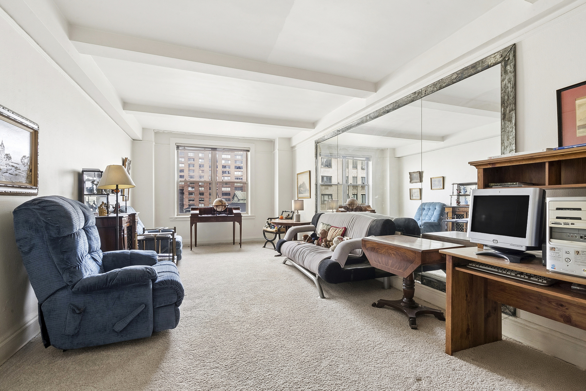 12 West 96th Street, Unit 9A Manhattan, NY 10025 - Photo 7 of 14 a living room with furniture flat screen tv and a window