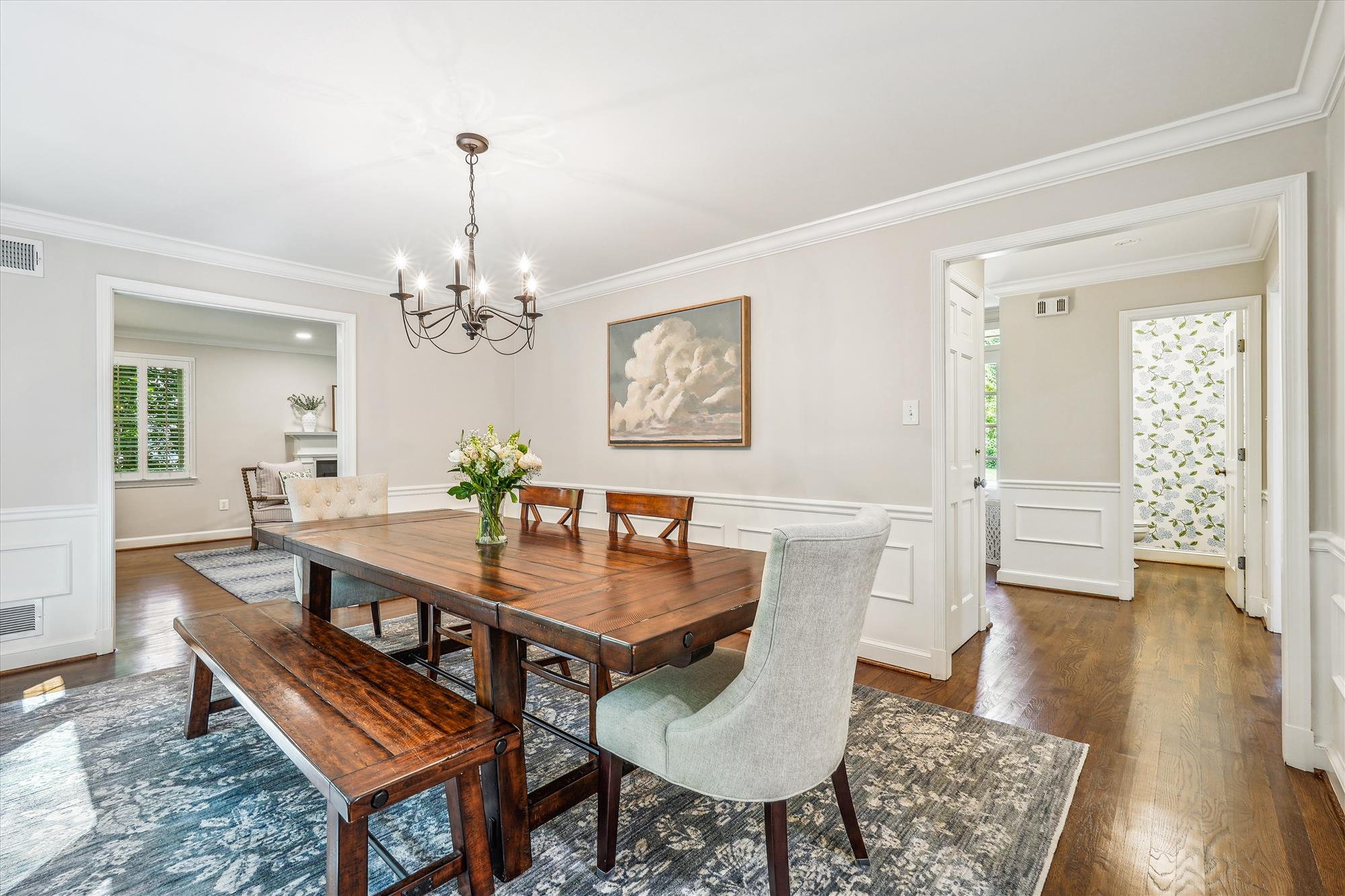 9904 Carter Road Bethesda, MD 20817 - Photo 10 of 41 a dining room with wooden floor a chandelier a wooden table and chairs
