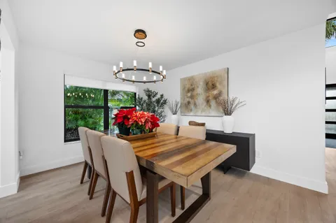 a view of a dining room with furniture and chandelier
