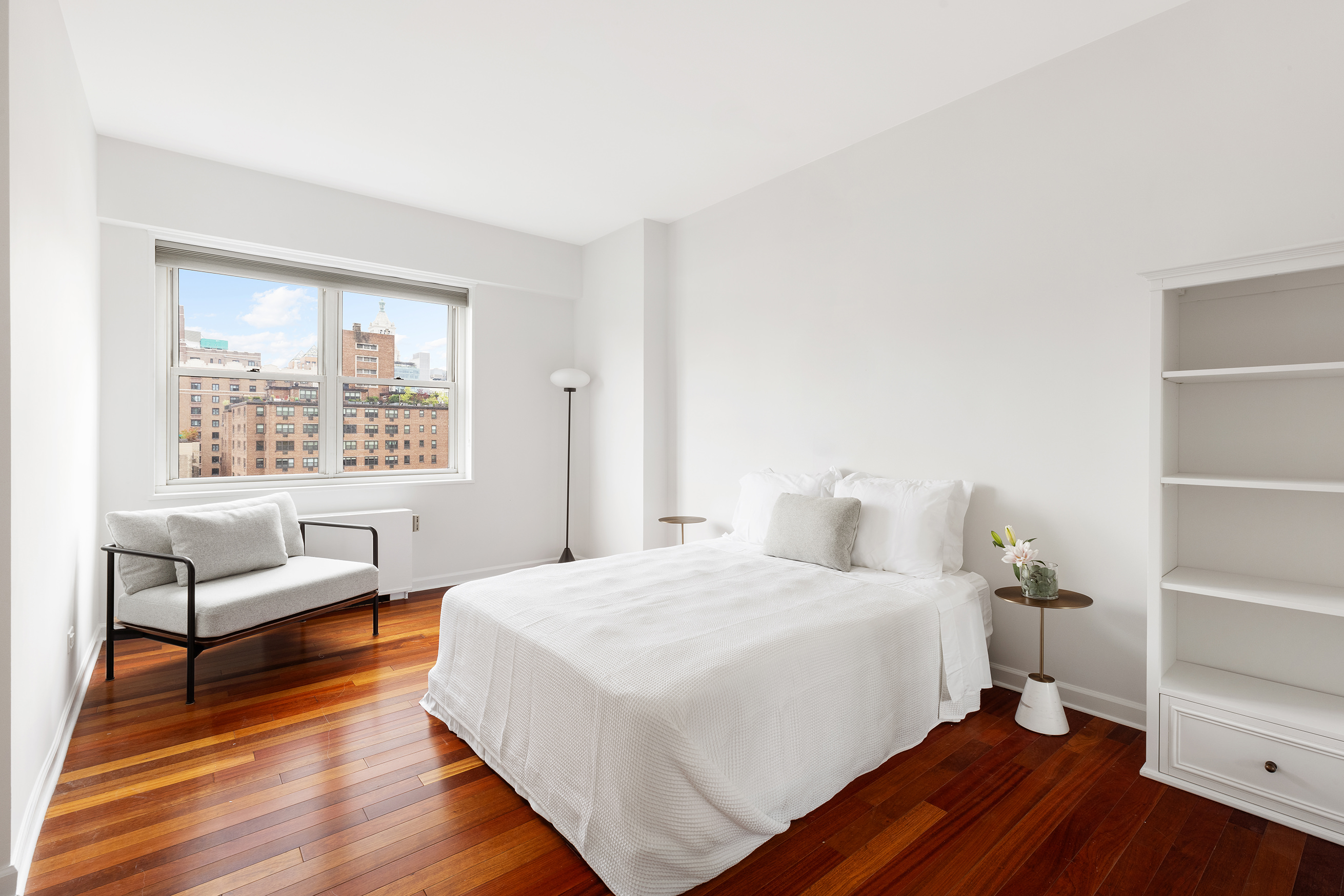 60 East 8th Street, Unit 10E Manhattan, NY 10003 - Photo 6 of 13 a bedroom with a bed and a window