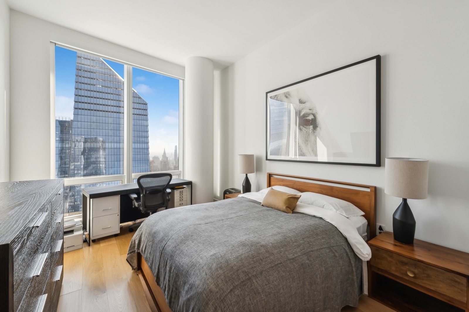 15 Hudson Yards, Unit 74F Manhattan, NY 10001 - Photo 8 of 13 a bedroom with a large bed and a desk
