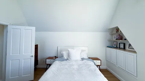 a bedroom with a bed and cabinets