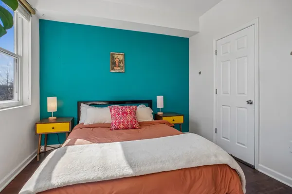 a bedroom with a bed and a window