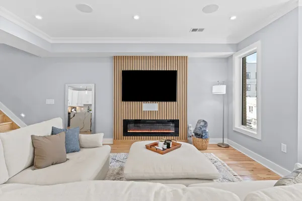a living room with furniture a fireplace and a flat screen tv