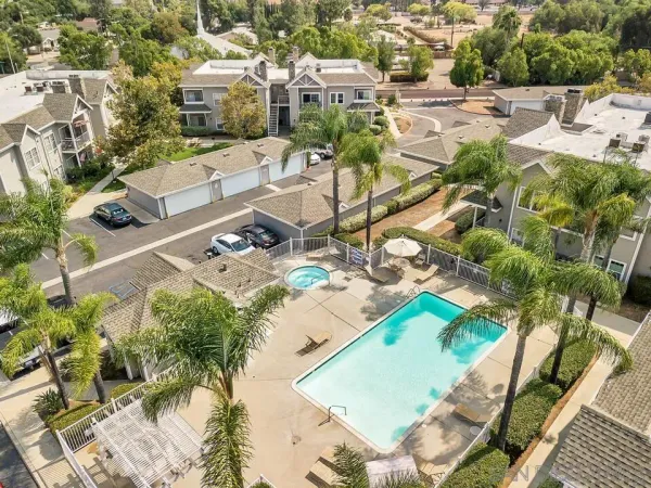 a view of a patio with table and chairs potted plants and large tree