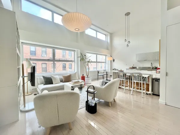a living room with furniture and a chandelier