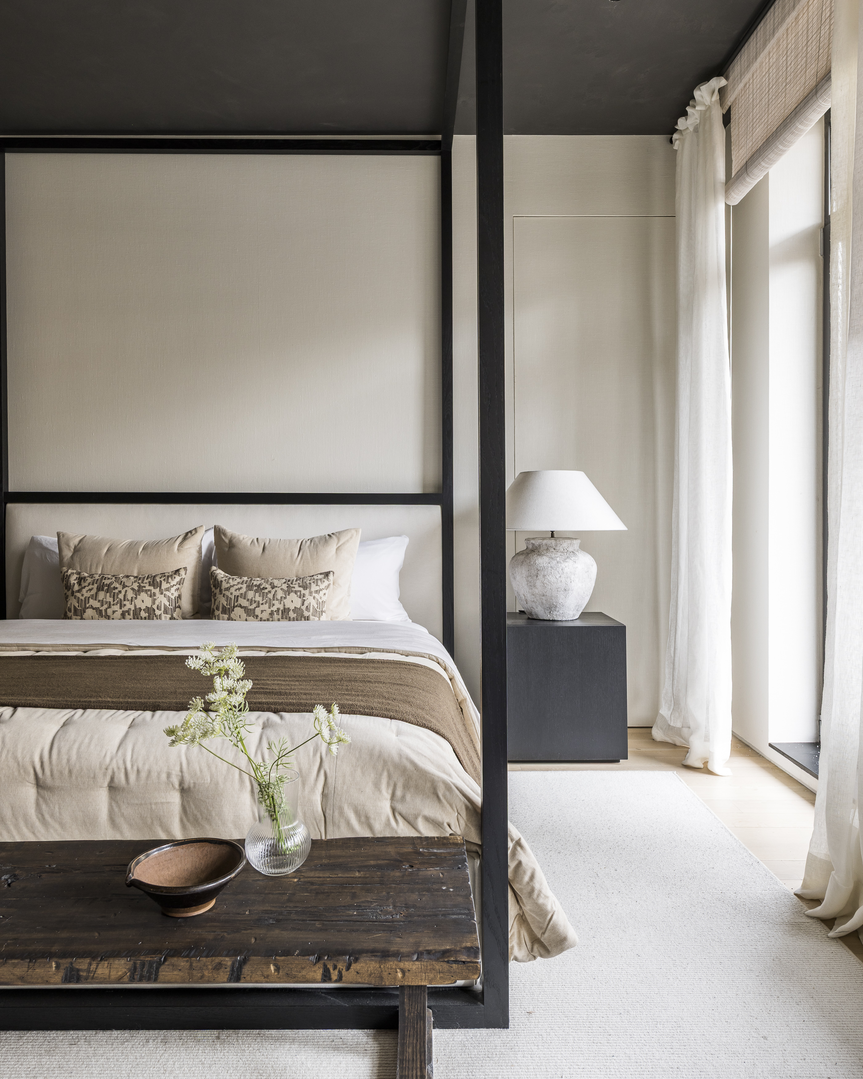 415 Washington Street, Unit 5A Manhattan, NY 10013 - Photo 11 of 21 a bed sitting in a bedroom next to a window with lamp