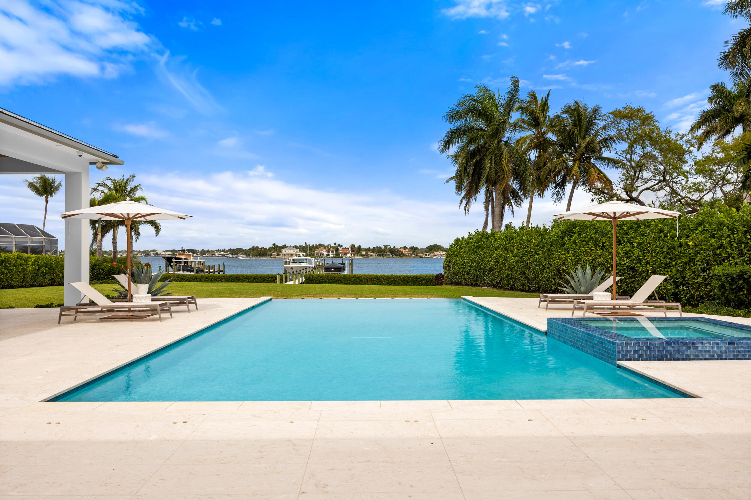 5695 Pennock Point Road Jupiter, FL 33458 - Photo 13 of 77 a view of a swimming pool and lounge chair
