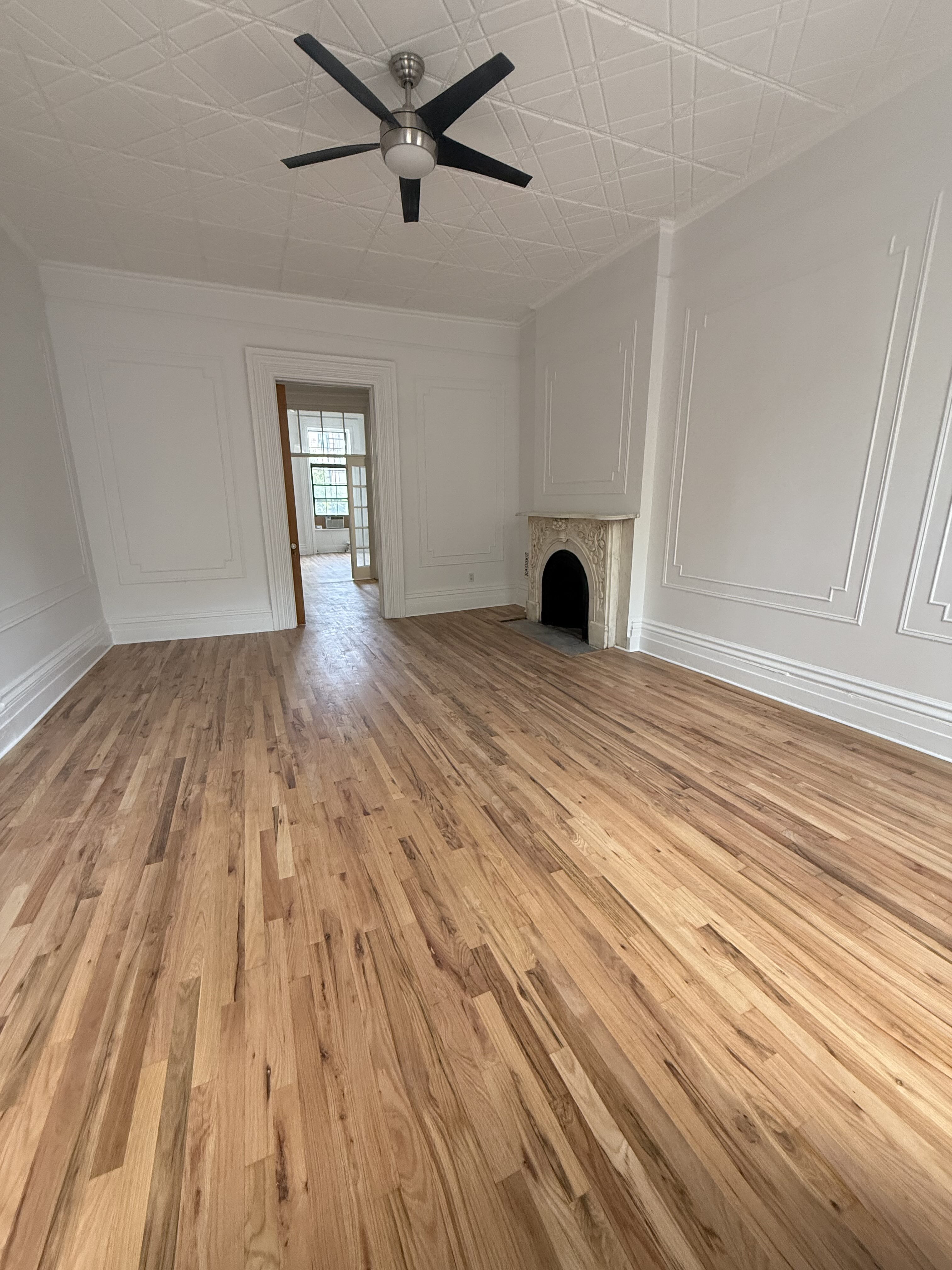 141 Summit Street, Unit 2 Brooklyn, NY 11231 - Photo 8 of 12 a view of empty room with wooden floor and fan