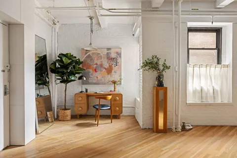 a view of a entryway with furniture and floor to ceiling window