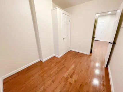 a view of a room with wooden floor