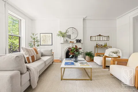 a living room with furniture and floor to ceiling windows