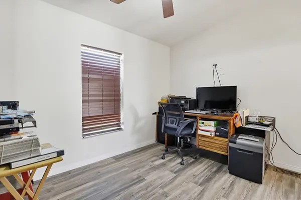 a view of a workspace with furniture and wooden floor