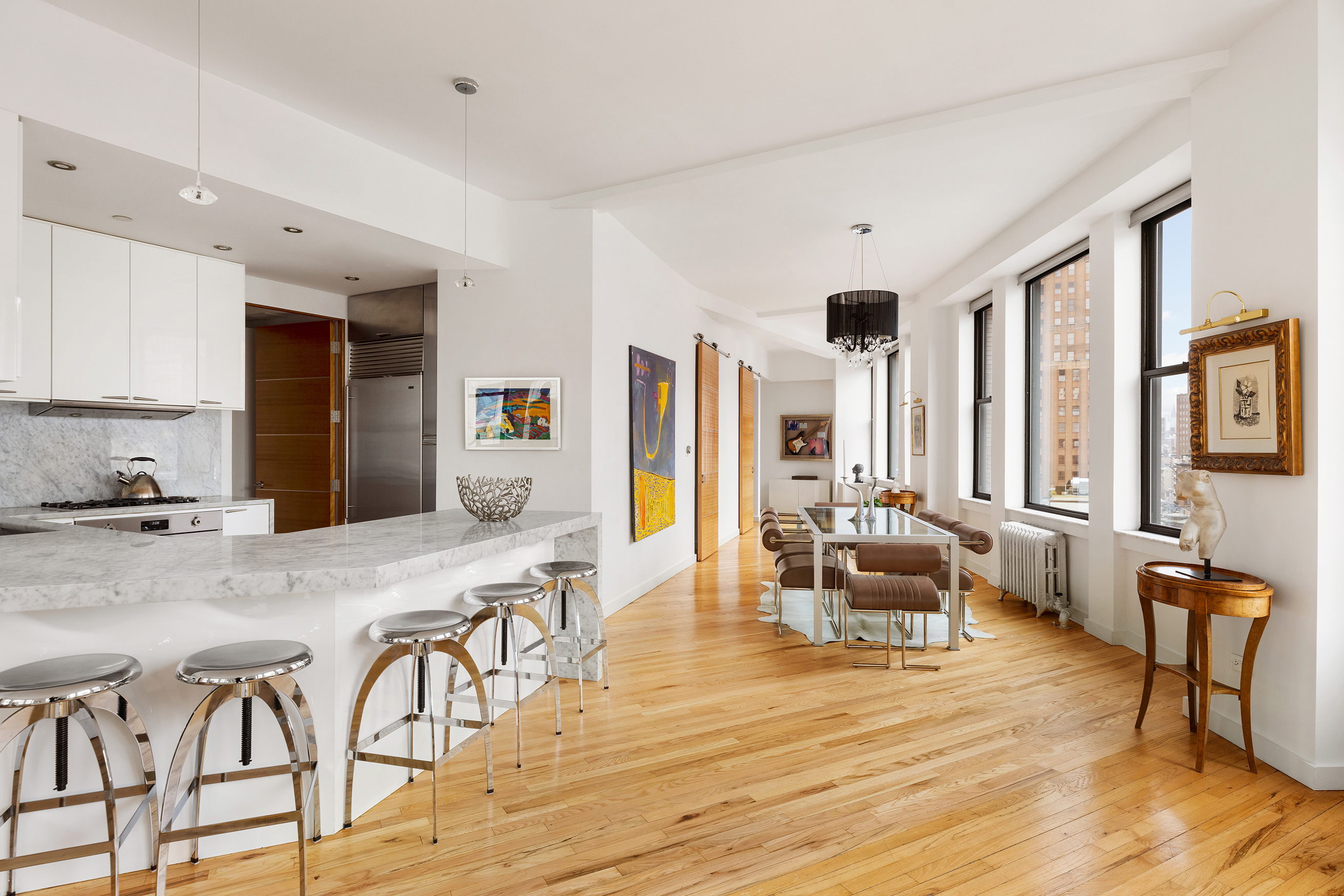 1 Hudson Street, Unit 9 Manhattan, NY 10013 - Photo 3 of 13 a living room with furniture and a wooden floor