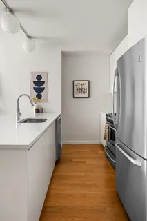 a kitchen with a refrigerator and a sink