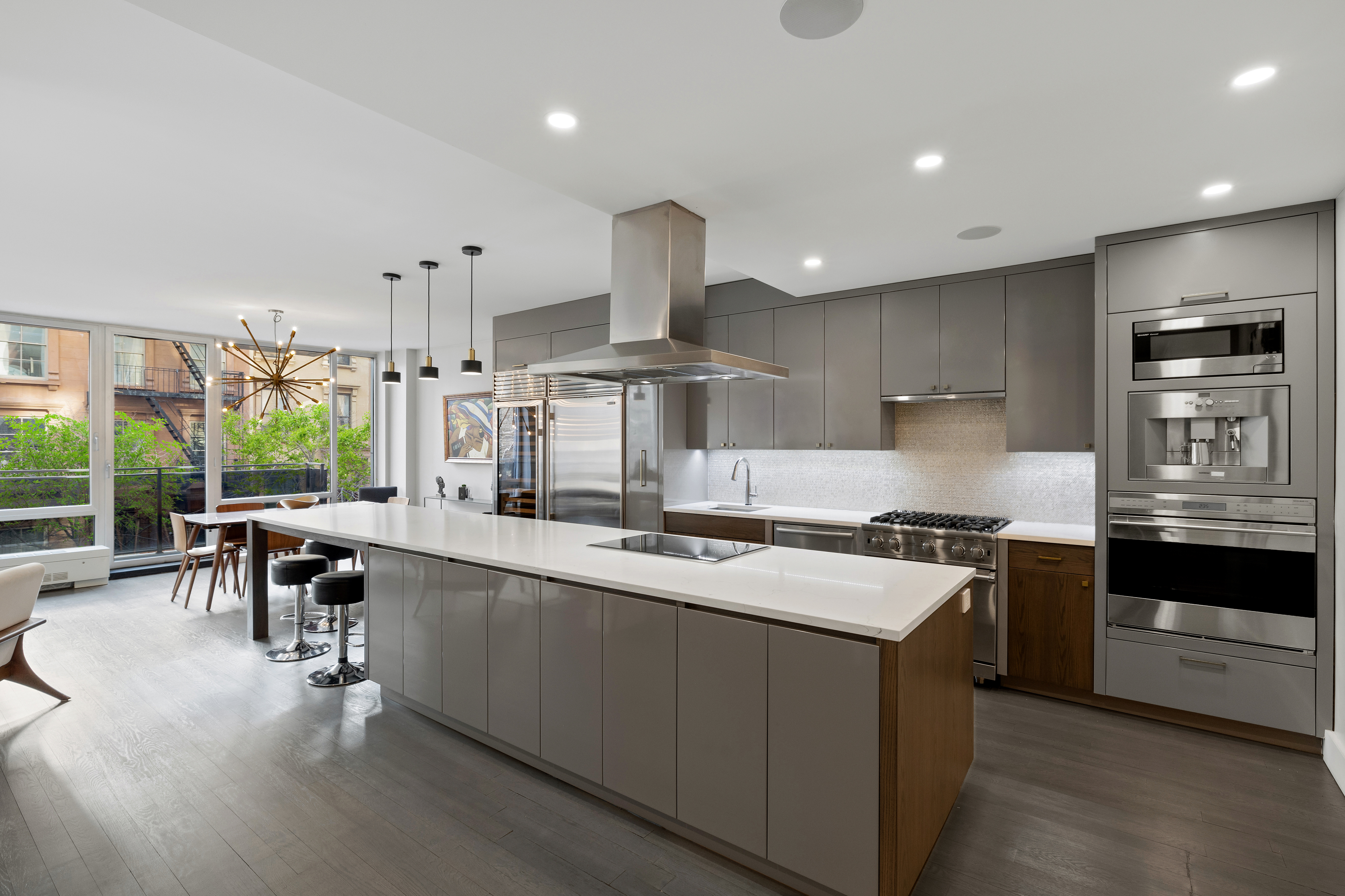a large kitchen with stainless steel appliances lots of counter space and a sink
