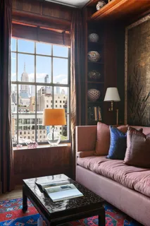 a living room with a couch and chandelier