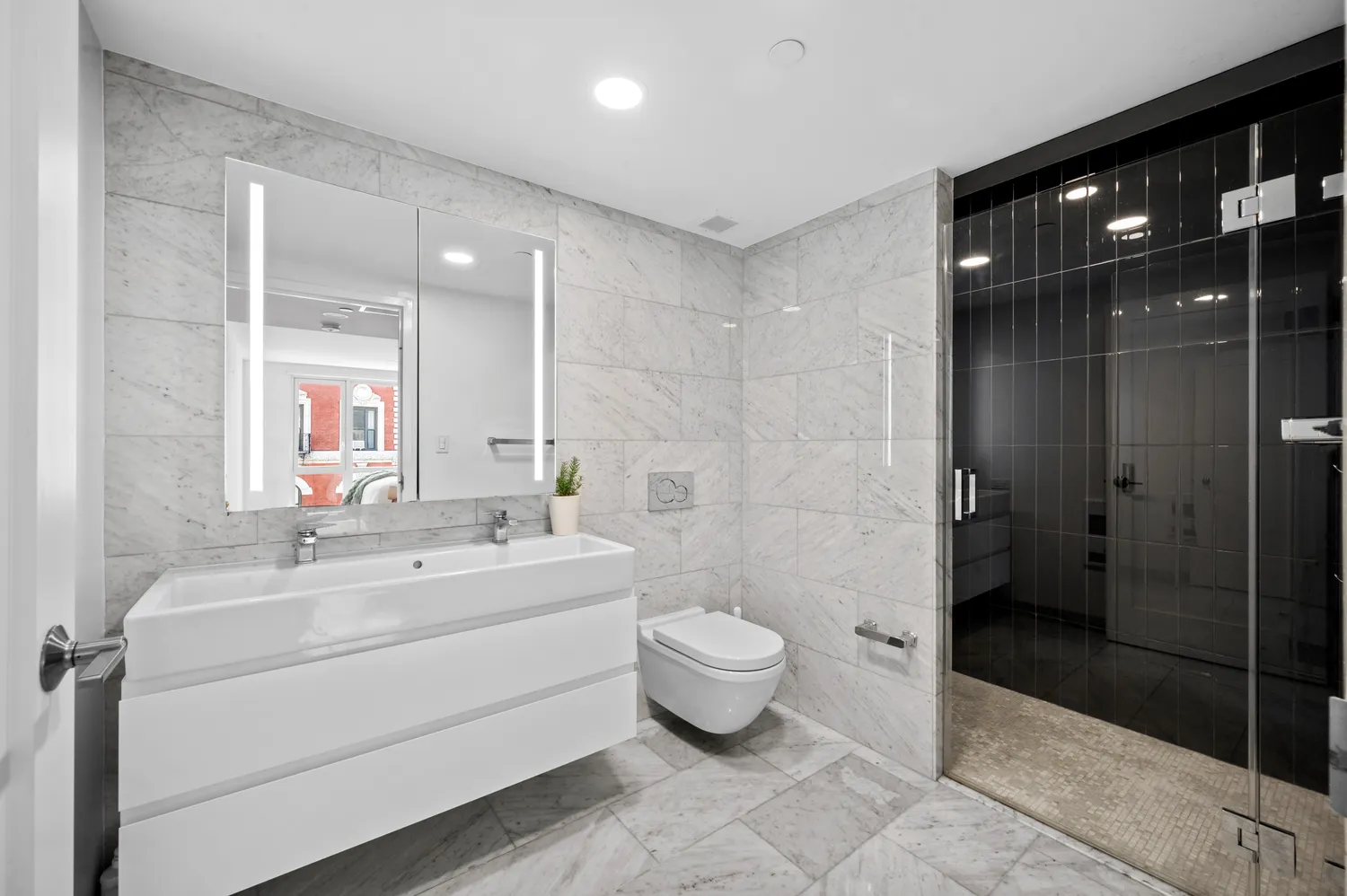 a bathroom with a bathtub shower sink mirror and toilet