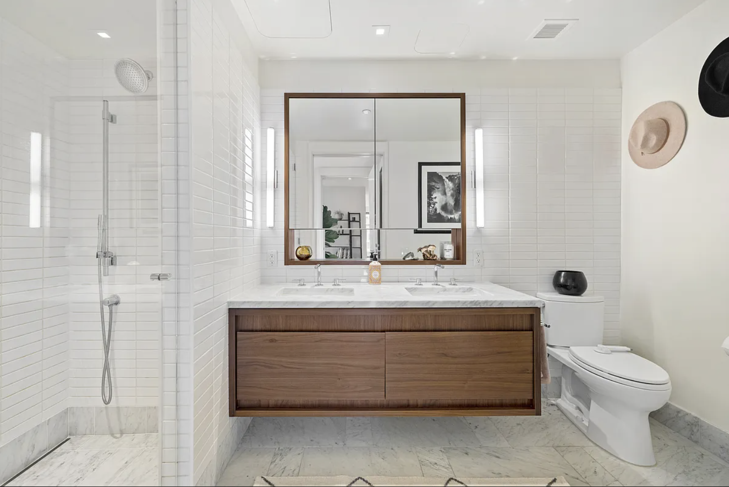 550 Vanderbilt Avenue, Unit 525 Brooklyn, NY 11238 - Photo 5 of 6 a bathroom with a granite countertop sink a toilet and a mirror