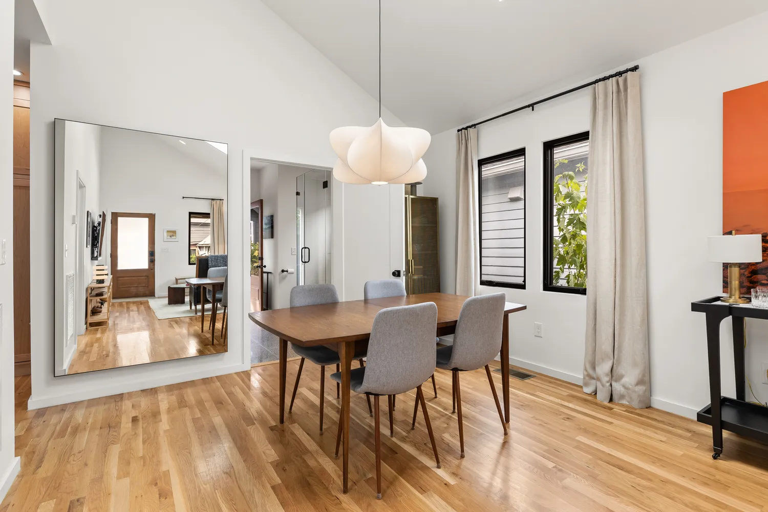 a view of a a dining room with furniture window and wooden floor