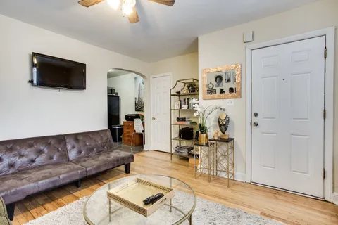 a living room with furniture and a flat screen tv