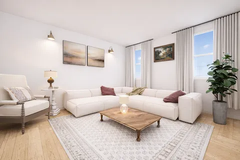 a living room with furniture and a potted plant