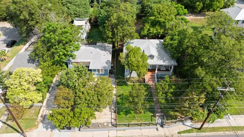 an aerial view of a house with a yard