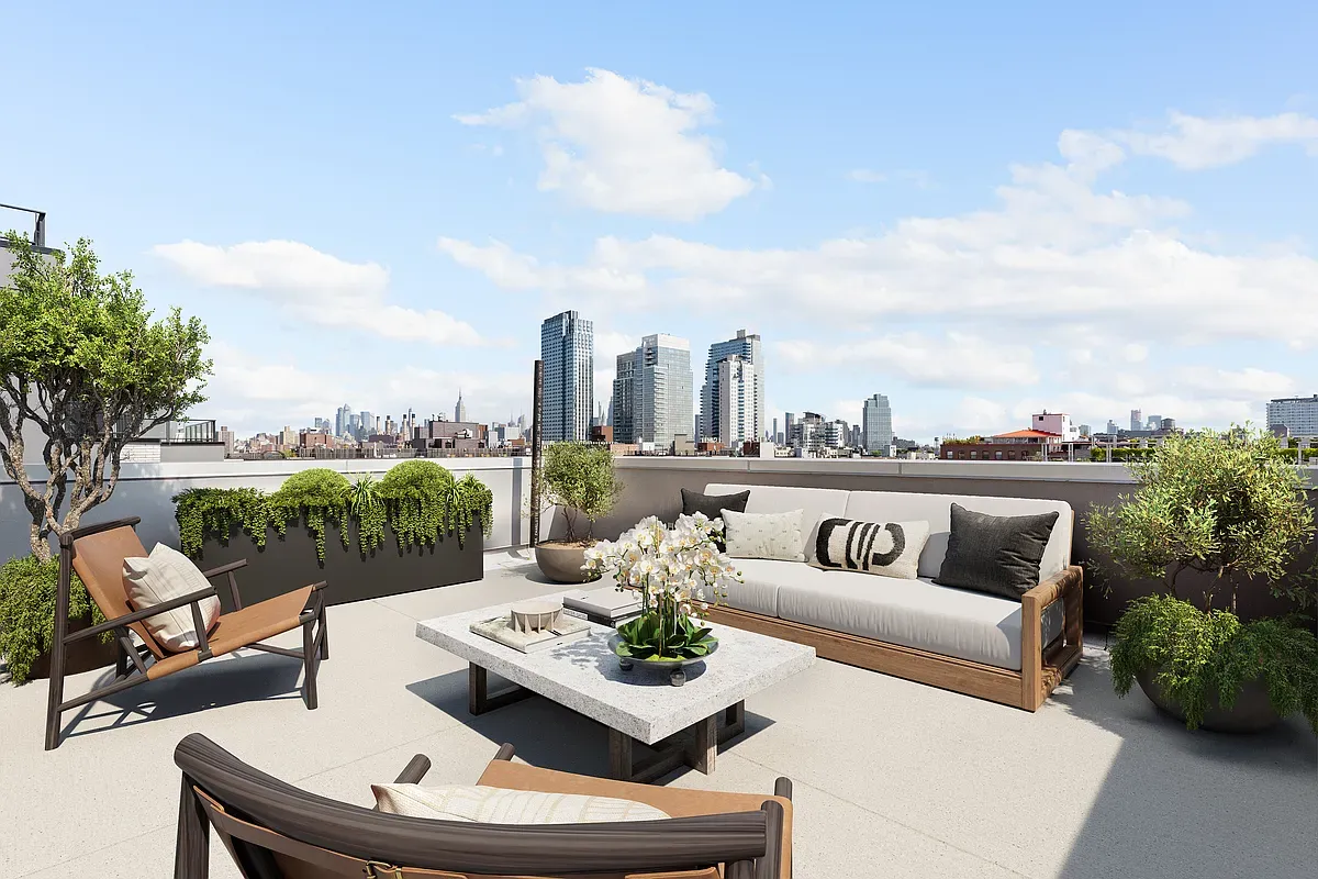 a view of a roof deck with couches and potted plants