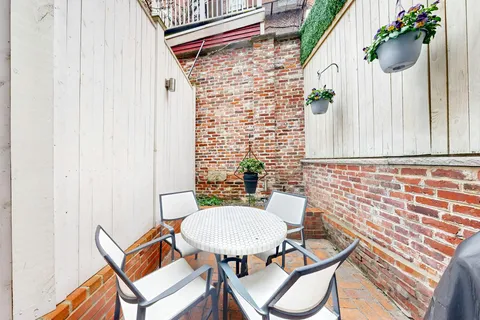 a view of balcony with wooden floor and fence