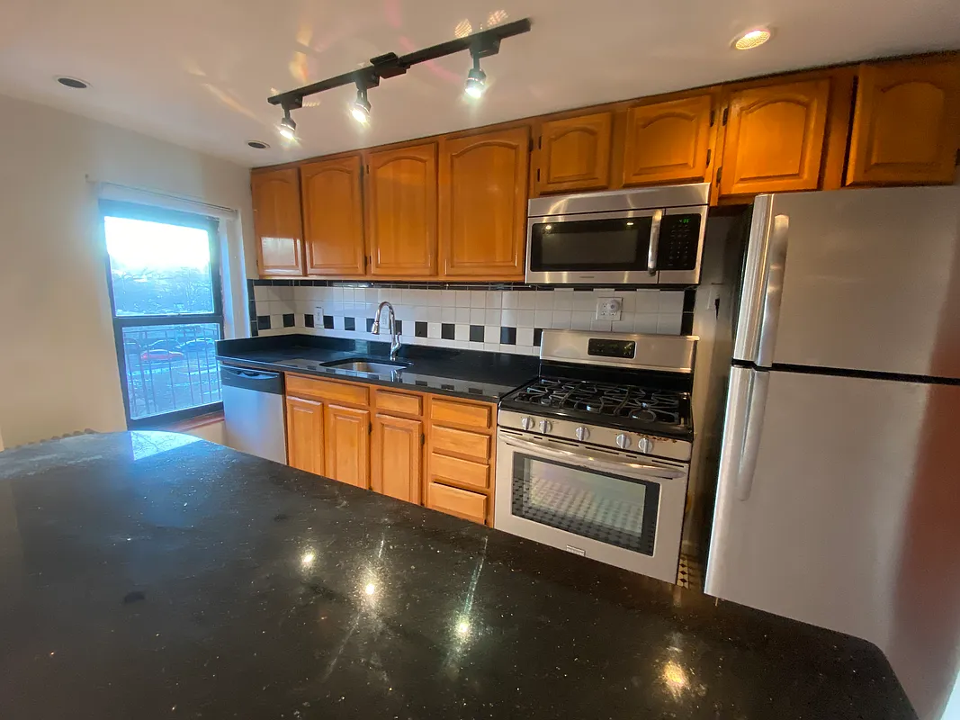62 Bainbridge Street, Unit 4 Brooklyn, NY 11233 - Photo 2 of 8 a kitchen with stainless steel appliances a sink stove and refrigerator