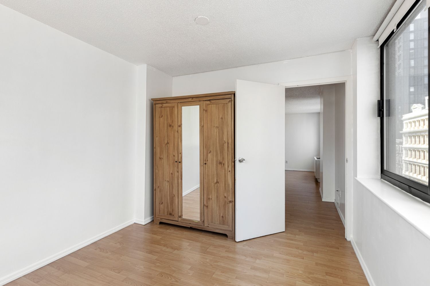 376 Broadway, Unit 8F Manhattan, NY 10013 - Photo 7 of 20 a view of an empty room with a window