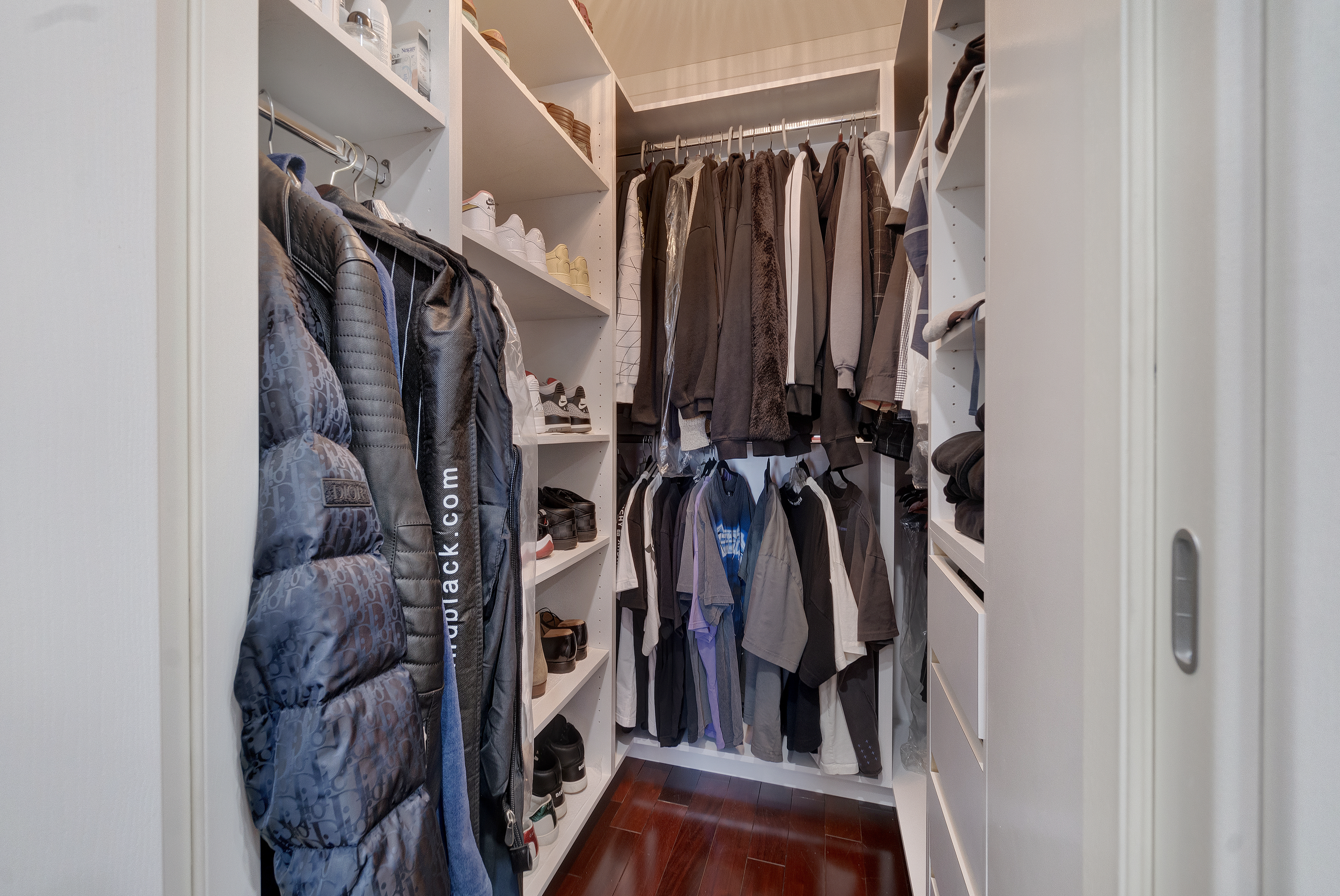 448 Neptune Avenue, Unit 14L Brooklyn, NY 11224 - Photo 11 of 20 a view of walk in closet with clothes and shoes