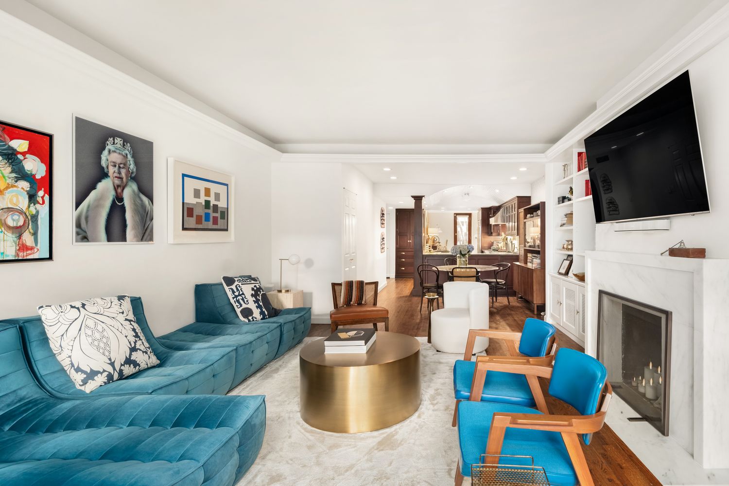 a living room with furniture a flat screen tv and a fireplace