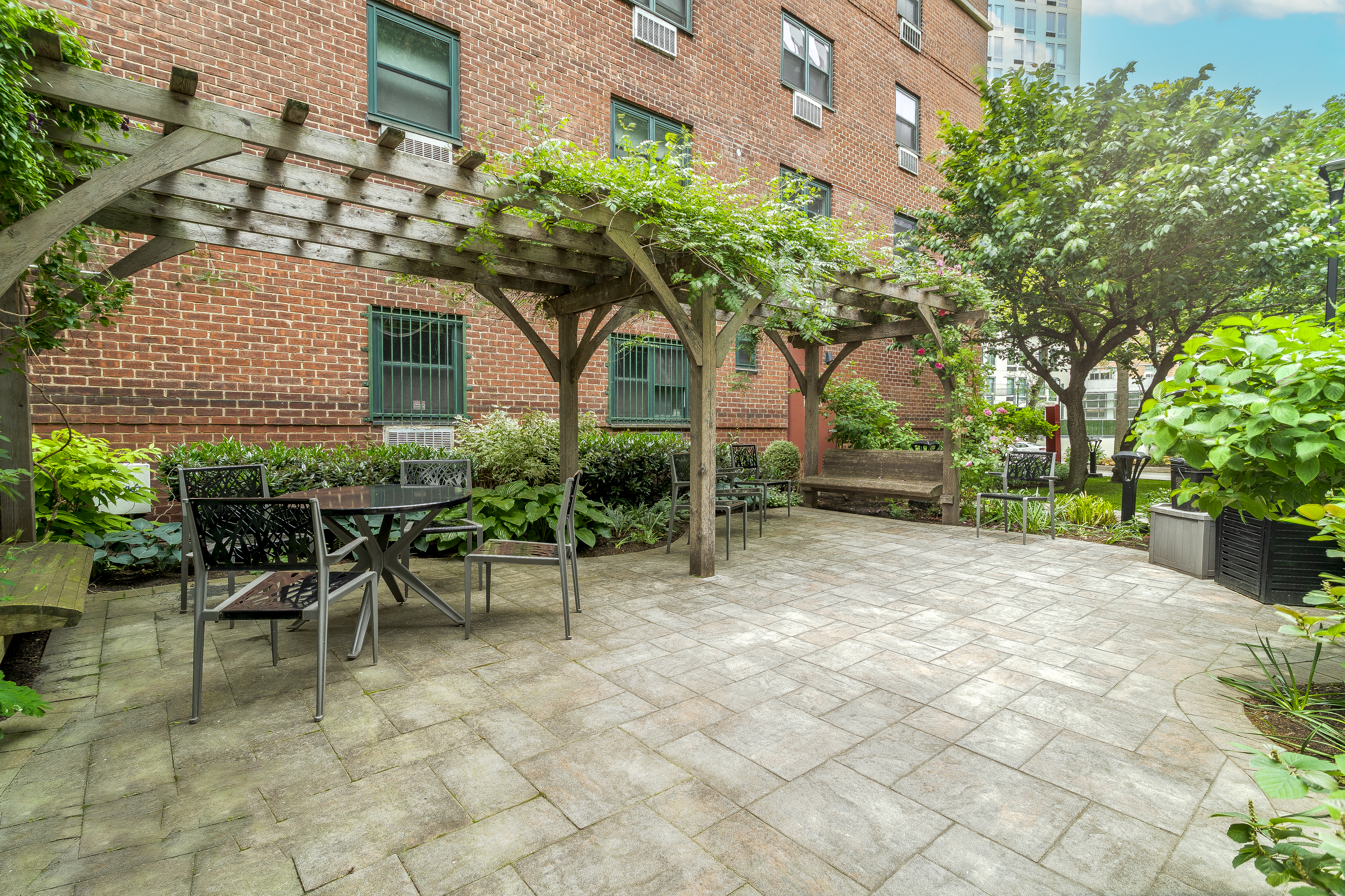 191 Willoughby Street, Unit 12J Brooklyn, NY 11201 - Photo 14 of 19 a view of a patio with table and chairs and potted plants