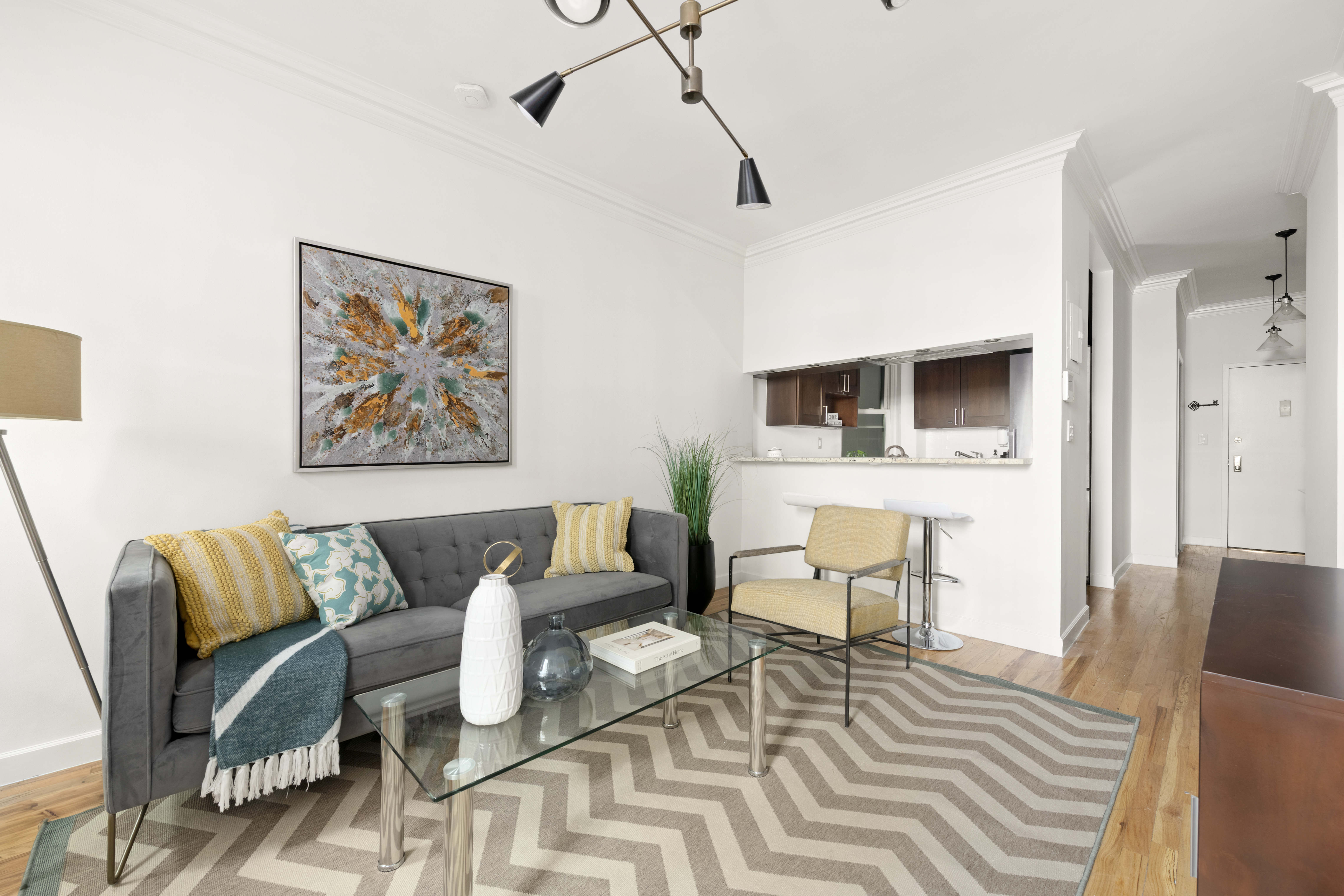 323 West 43rd Street, Unit 1R Manhattan, NY 10036 - Photo 2 of 8 a living room with furniture and wooden floor