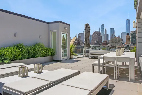 a view of a patio with table and chairs and potted plants