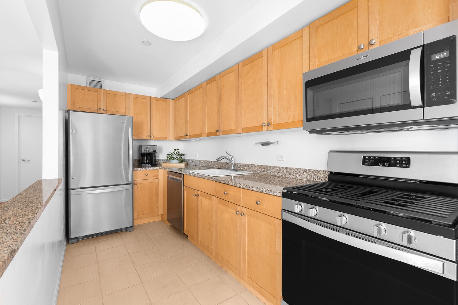 300 West 145th Street, Unit 1QQ Manhattan, NY 10039 - Photo 2 of 15 a kitchen with a refrigerator stove and microwave