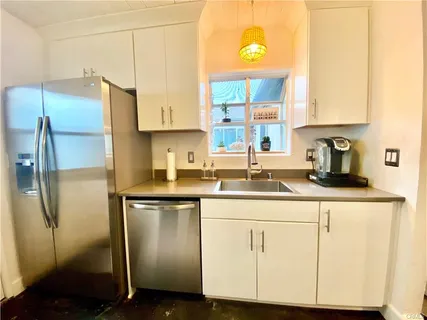 a kitchen with cabinets and stainless steel appliances