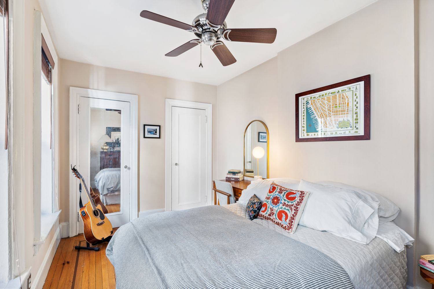 104 Bedford Street, Unit 4C Manhattan, NY 10014 - Photo 3 of 9 a bedroom with a bed and a chandelier