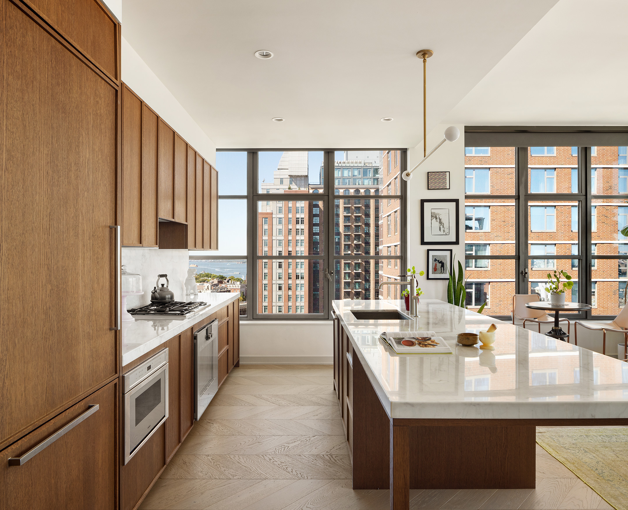 115 York Street, Unit 17A Brooklyn, NY 11201 - Photo 5 of 12 a kitchen with kitchen island a sink and a large window