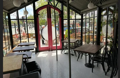 a view of a room with furniture and large windows